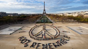A large scale visual message made by hundreds of people promoting a 100% renewable energy and peace during the COP21 climate summit. The event was created in Paris by the international artist John Quigley.